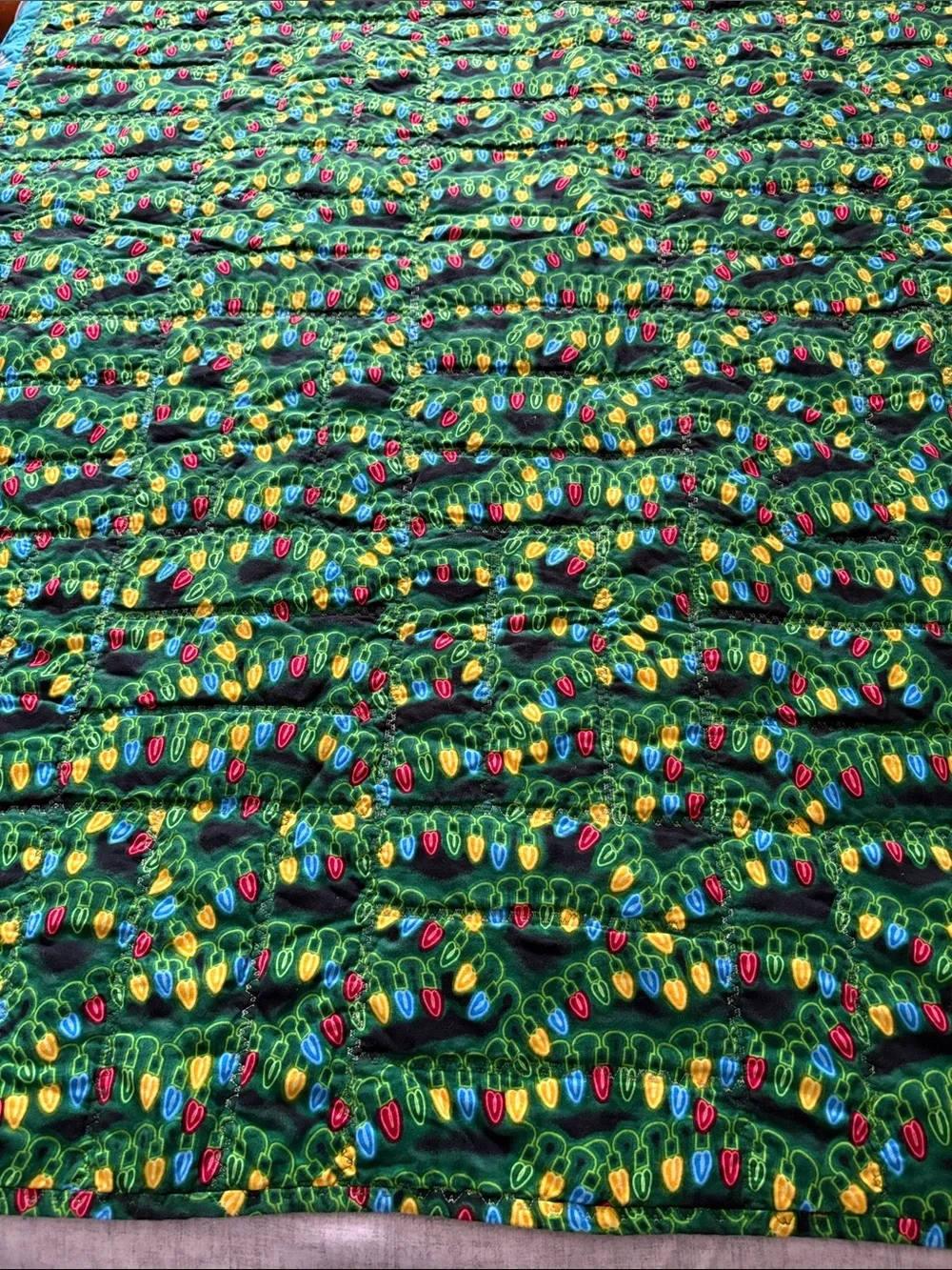 Child’s Reversible Christmas Quilt. Size 55”X 40”.